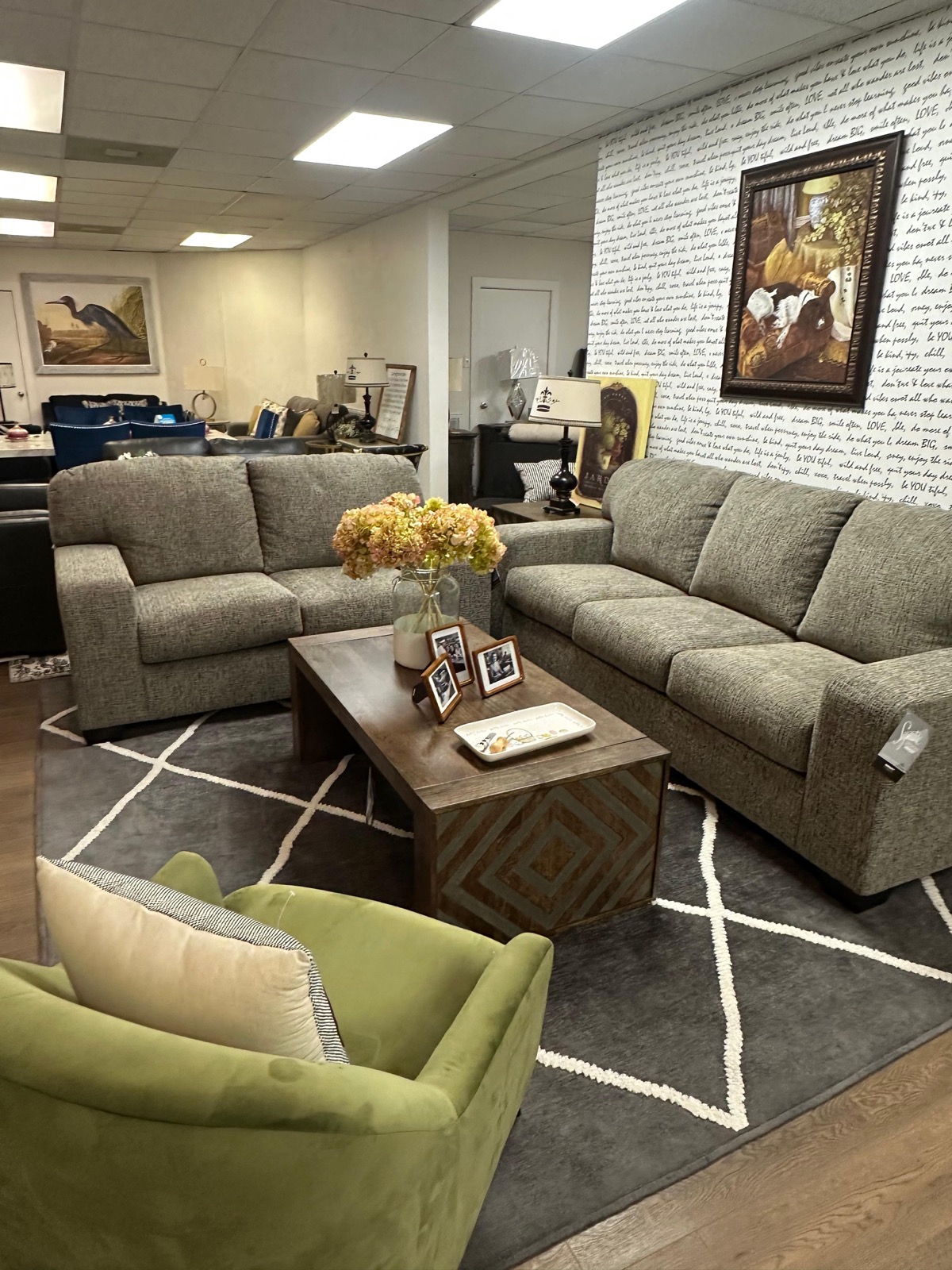Gray sofa and loveseat set with green accent chair and coffee table at Metropolitan Market and Decor Houston