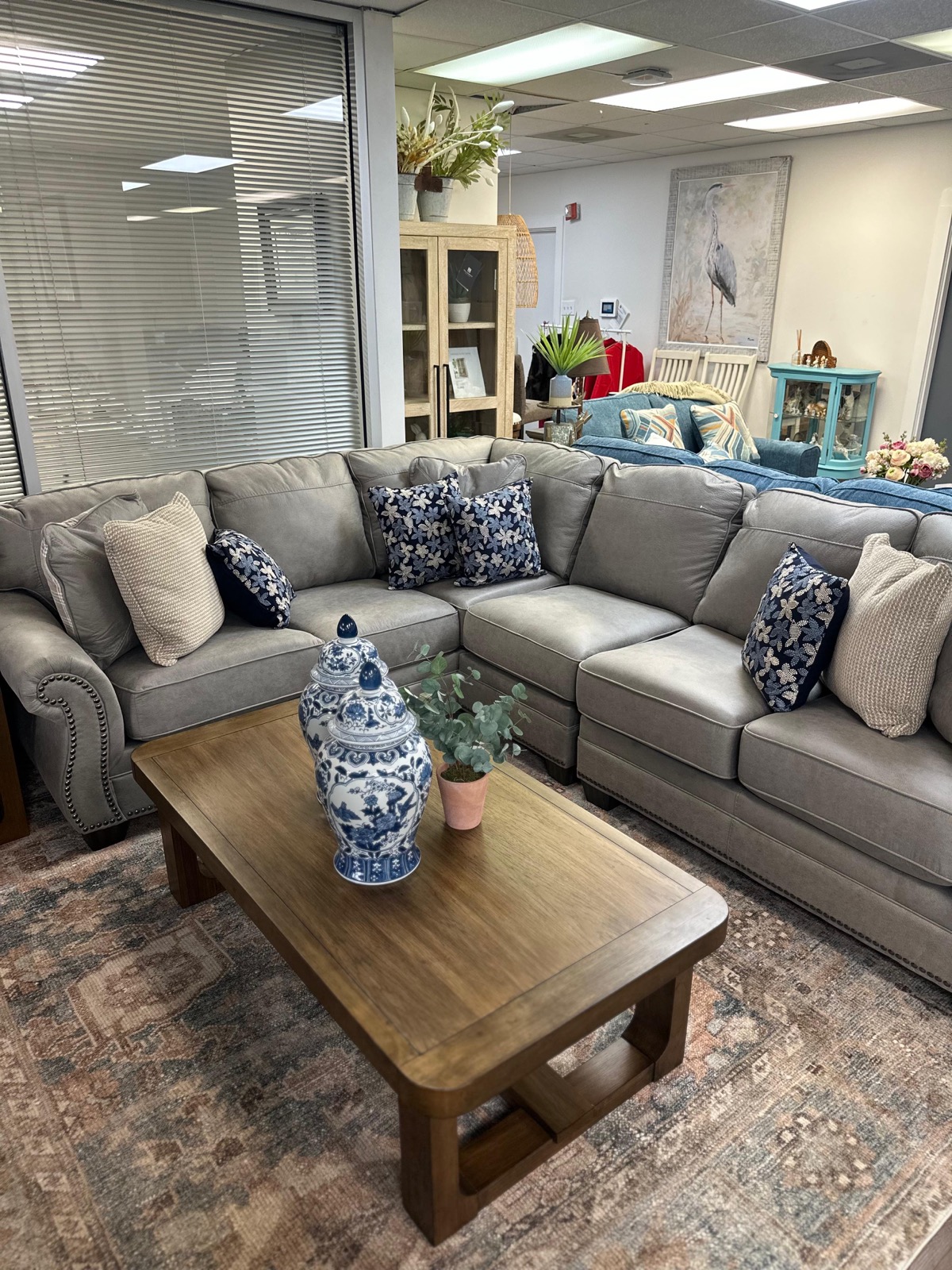 Sectional sofa with blue and white decorative pillows at Metropolitan Market and Decor Houston