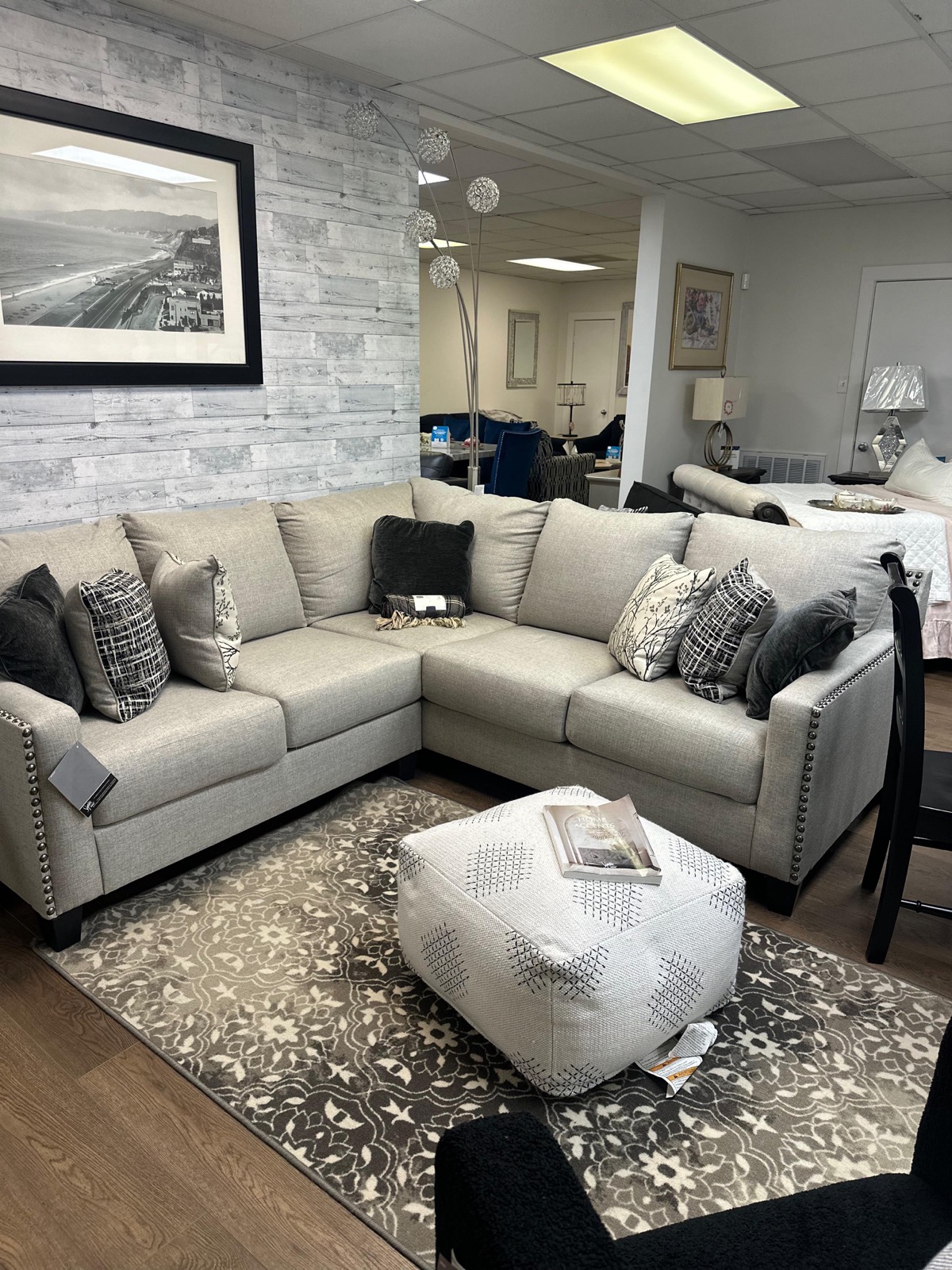 Beige sectional sofa with ottoman and floral area rug